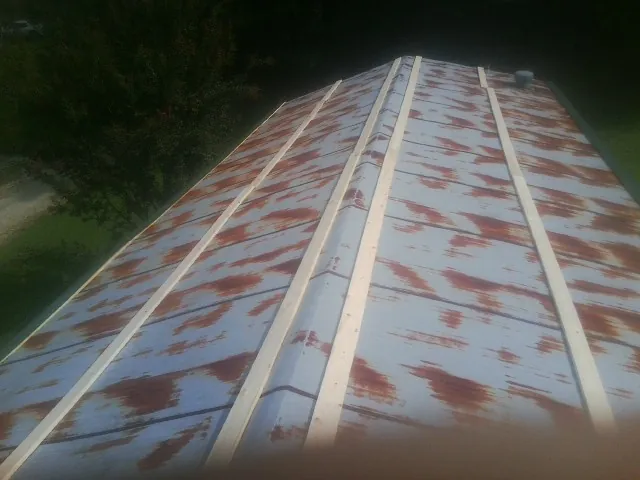 Rusted metal roof panels with new wood purlins before replacement — Storm Damage Roof Repair in Cuddy by Roofing Brothers